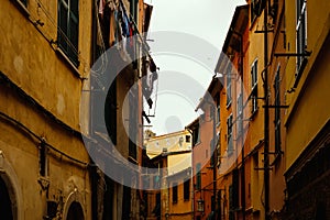 Yellow and red bright houses on narrow traditional streets of an Italian town.