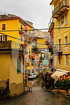 Yellow and red bright houses on narrow traditional streets of an Italian town.