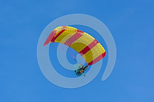 Yellow and red canopy powered tandem para glider