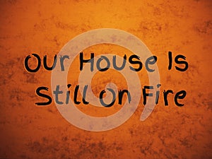 Yellow red dirty tan background with Greta Thunberg`s message at Davos Forum: Our House Is Still On Fire. Global warming problem. photo