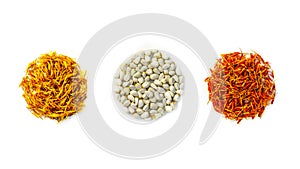 Safflower Carthamus tinctorius. Yellow, red dried petals and seeds are folded in the form of circles on a white background. photo