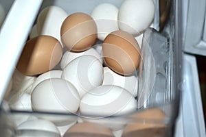 Yellow red eggs in a compartment in the refrigerator