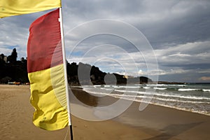 Yellow and red flags beach warning preventing lifesaving sign swimming between those flag