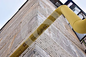 Yellow and red gas pipe with a valve at the house