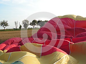 A yellow-red-green balloon during air filling