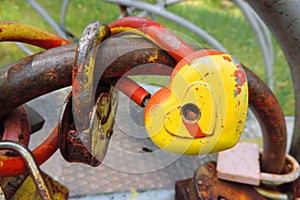 Yellow-red heart-shaped lock on the railing , sign of eternal love of the newlyweds