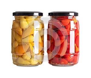 Yellow and red hot baby peppers, small hot chilis, pickled in glass jars
