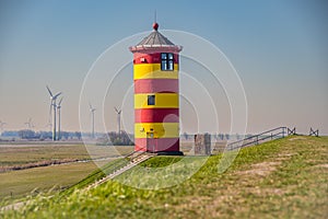 The yellow red lighthouse of Pilsum on a sunny day