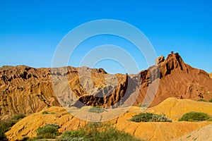 Yellow and red mountain rock formation valley fairy tale canyon in Kirgyzstan