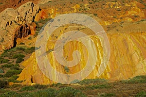 Yellow and red mountain rock formation valley fairy tale canyon in Kirgyzstan