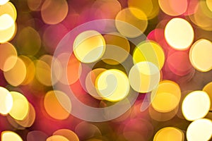 Yellow, red and orange glitter -- abstract festive elegant background with blurred bokeh lights.