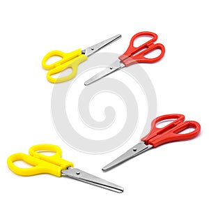 Yellow and red plastic scissors isolated on white.