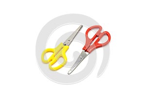 Yellow and red plastic scissors isolated on white.