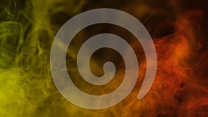 Yellow and red smoke close up on black background