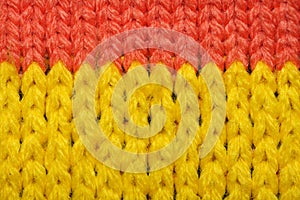 Yellow and red synthetic knitted fabric texture