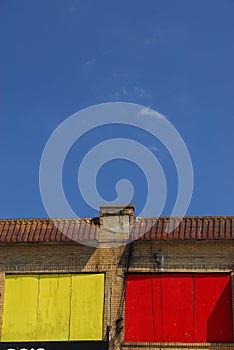 Yellow and red windows against a blue sky