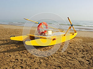 Yellow rescue boat on Italian beach. Adriatic sea. Emilia Romagna. Italy