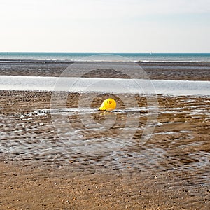 Yellow rescue buoy on the beach
