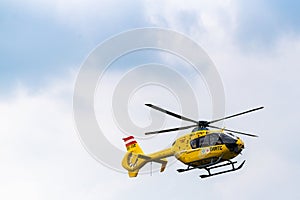 Yellow rescue helicopter taking off after intervention