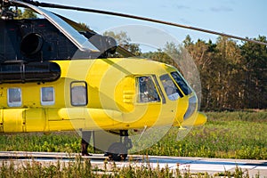 Yellow rescue medical helicopter at the site outside the city