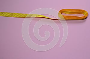 Yellow ribbon on a pink millennial background