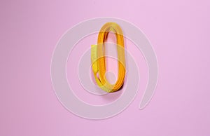 Yellow ribbon on a pink millennial background. Zero