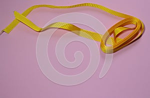 Yellow ribbon on a pink millennial background. Zero