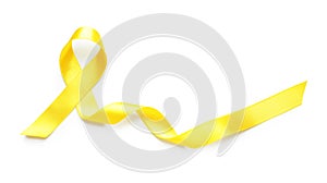 Yellow ribbon on white background. Cancer awareness concept photo