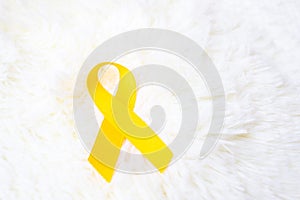 Yellow Ribbon on white background for supporting people living and illness. September Suicide prevention day, Childhood Cancer