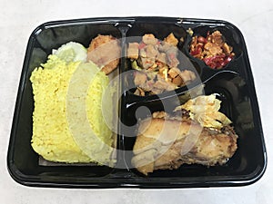 yellow rice with fried chicken and potatoes