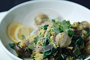 Yellow rice with mushrooms and spinach. Vegan dish