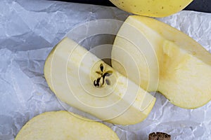 yellow ripe apple with cinnamon on the table