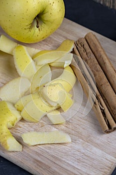 yellow ripe apple with cinnamon on the table