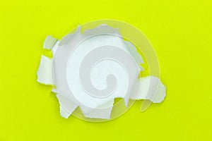 Yellow ripped open paper on white paper background.