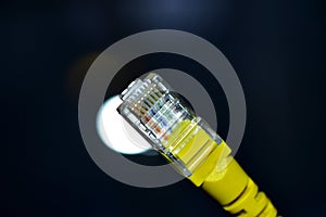 Yellow RJ-45 or ethernet internet cable close-up