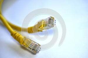 Yellow RJ-45 or ethernet internet cable on white background