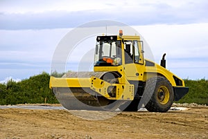 Yellow road roller at work