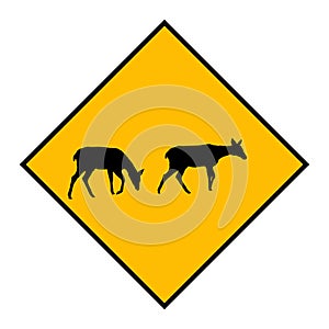 Yellow road sign: Deer Crossing Zone. Drive slowly for animal safety.