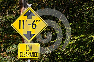 Yellow road sign, Low Clearance of 11â€™ 6â€, caution to tall vehicles