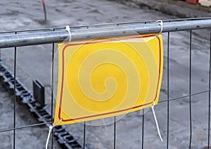 Yellow road sign on the road. Renovation work sign. Caution symbol under construction, road works in progress sign