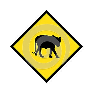 Yellow road sign: Tiger Crossing Zone. Drive slowly for animal safety.