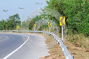 Yellow road signs warn Drivers for Ahead Dangerous Curve