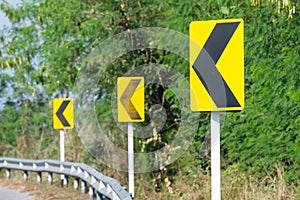 Yellow road signs warn Drivers for Ahead Dangerous Curve