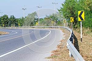 Yellow road signs warn Drivers for Ahead Dangerous Curve