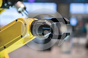 A yellow robotic arm photo
