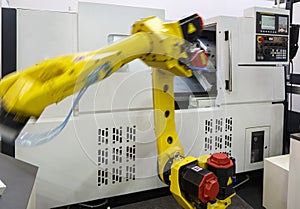 Yellow robotic hand in CNC machine center