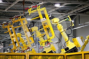 Yellow robots on a production line