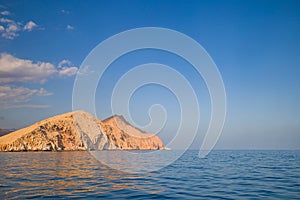 Yellow Rock in the sea far away from beach in sunny day in summer