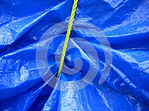 Yellow rope on blue tarpaulin