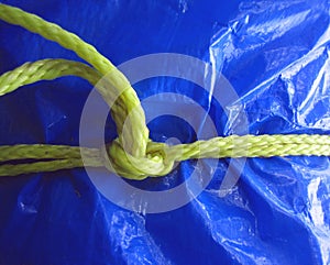 Yellow rope on blue tarpaulin